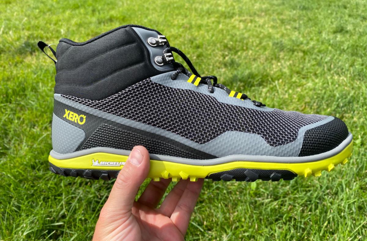 A picture of a black and yellow Xero Mid Scrambler against a grassy background.